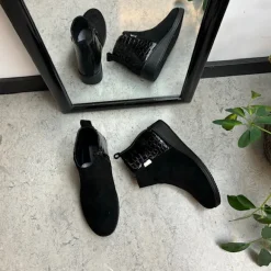 Kort sort støvle med lakdetaljer ved hælen